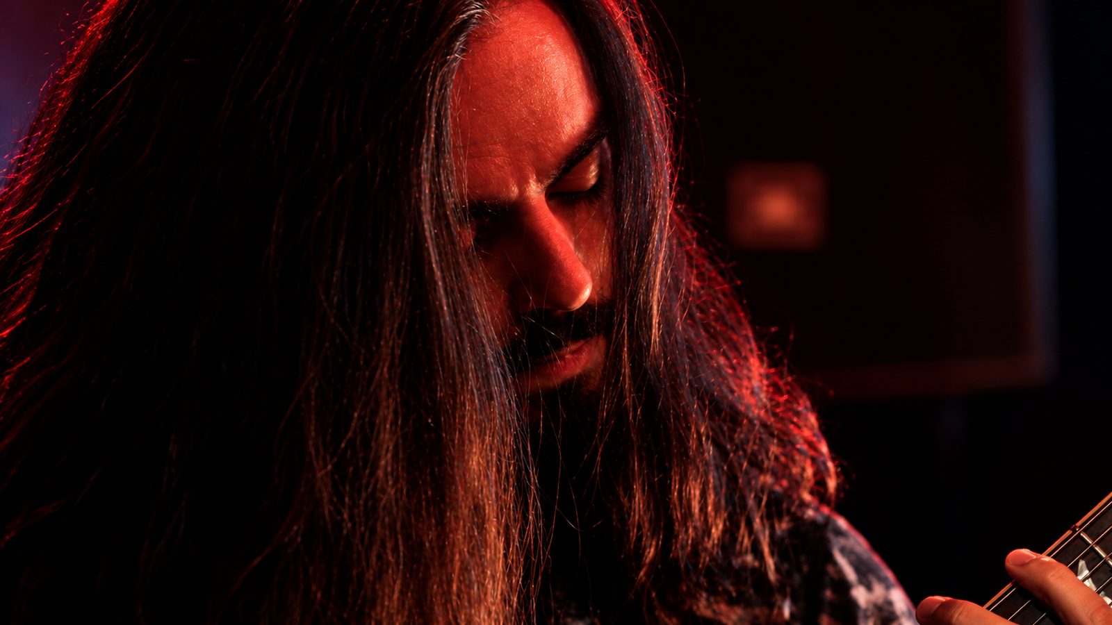Guitarrista sob luz vermelha